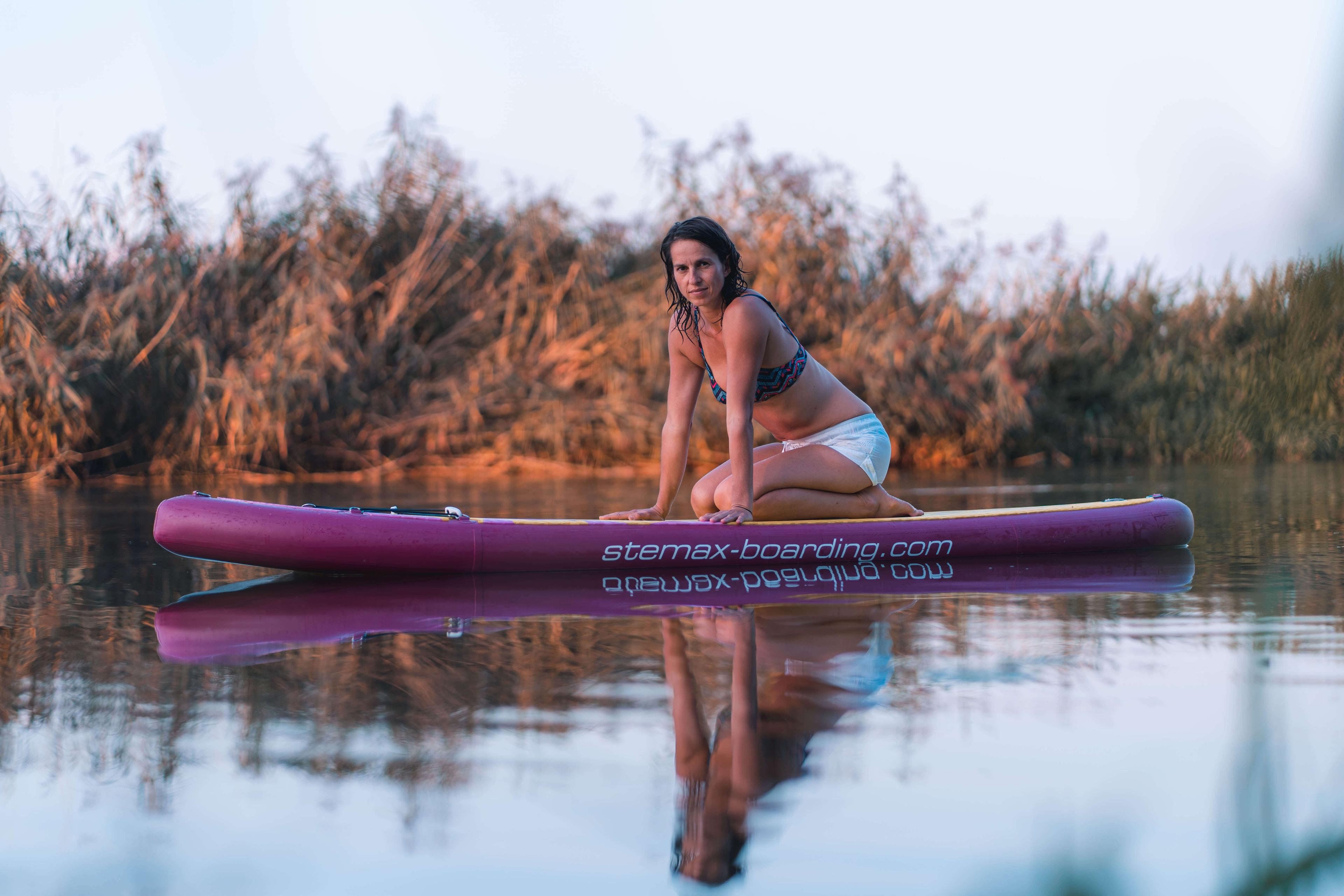 Stemax Boarding | Woman Kneeing on SUP in the Water