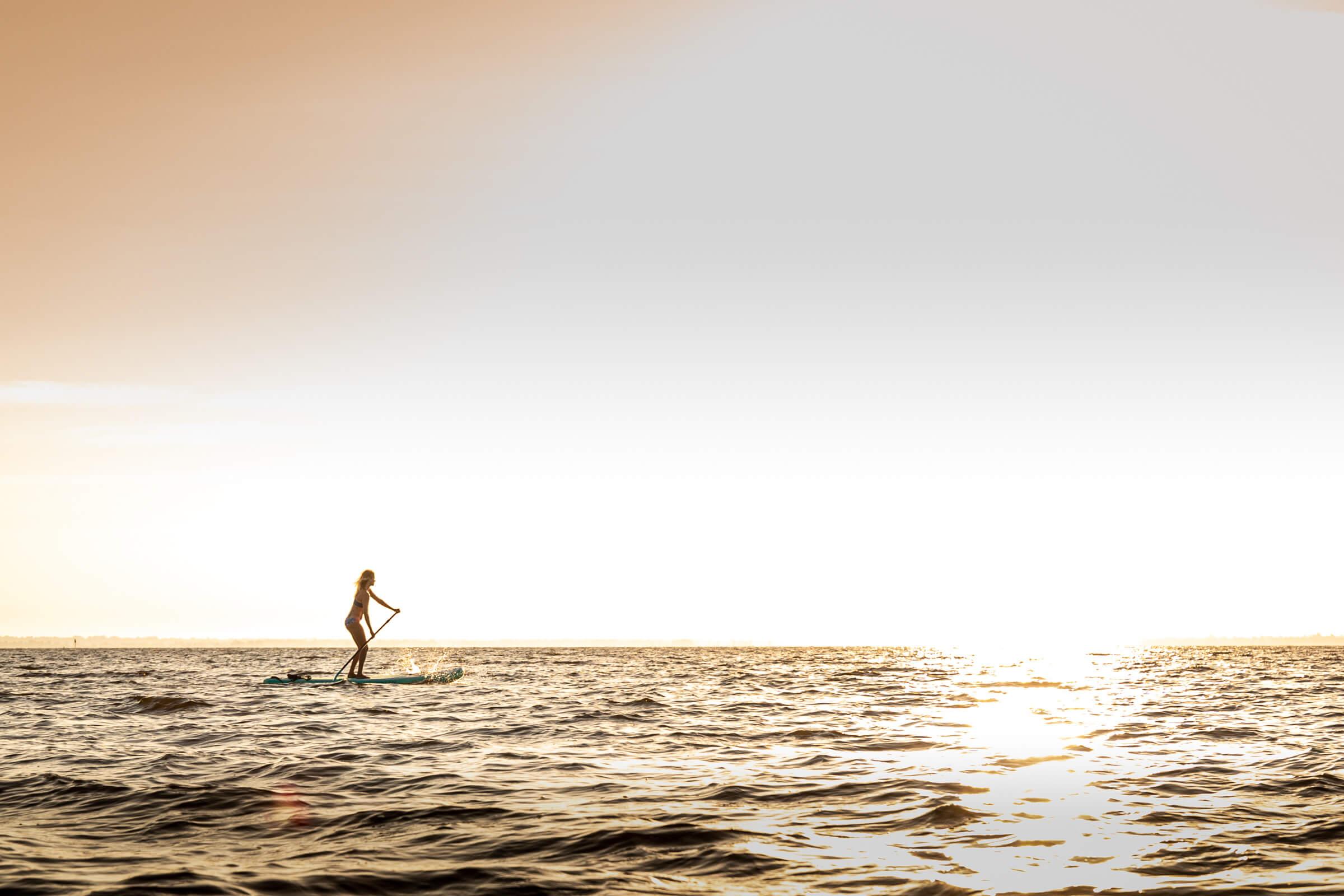 Yolo Board | Woman Paddling Sup In Ocean At Sunset